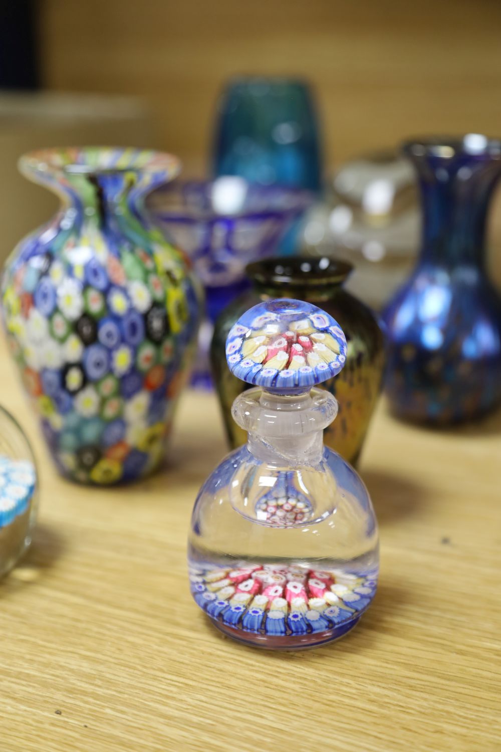 A millefiori weight, a scent bottle with stopper, a jar and six other coloured glass items